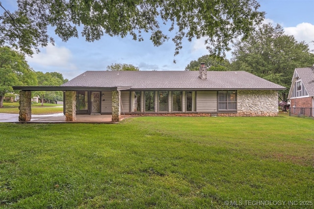 501 E Yuma Dr, Broken Arrow, OK 74011 - back of house with roof with shingles, a yard, and stone siding