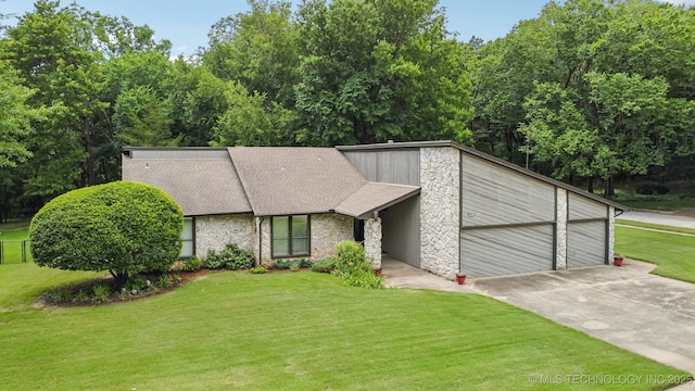 501 E Yuma Dr, Broken Arrow, OK 74011 - mid-century modern home featuring stone siding, driveway, a front lawn, a garage, and a shingled roof