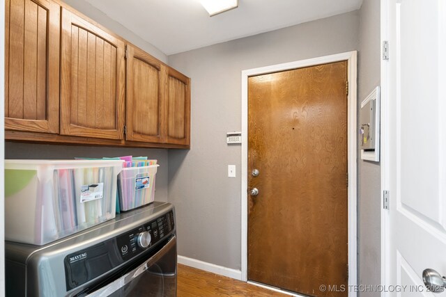 501 E Yuma Dr, Broken Arrow, OK 74011 - washroom with washer / clothes dryer, cabinet space, and wood finished floors