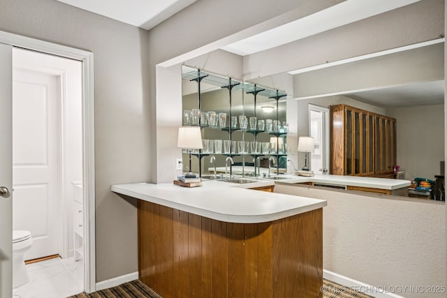 501 E Yuma Dr, Broken Arrow, OK 74011 - bar area featuring baseboards and marble look tiles