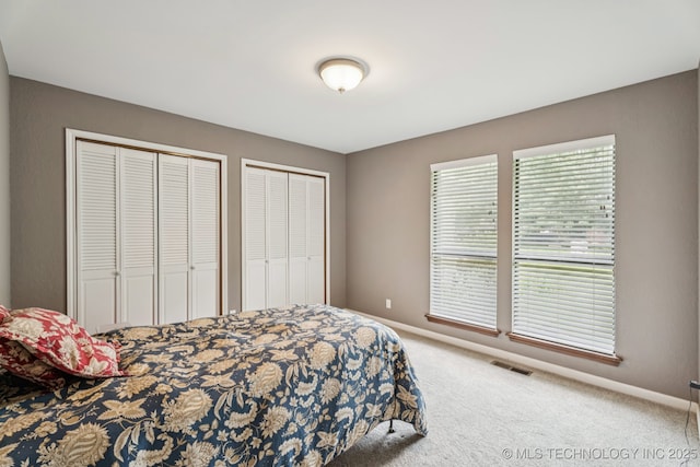 501 E Yuma Dr, Broken Arrow, OK 74011 - carpeted bedroom featuring two closets and baseboards