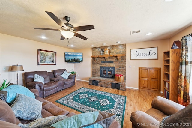 living area featuring recessed lighting, wood finished floors, visible vents, a ceiling fan, and baseboards