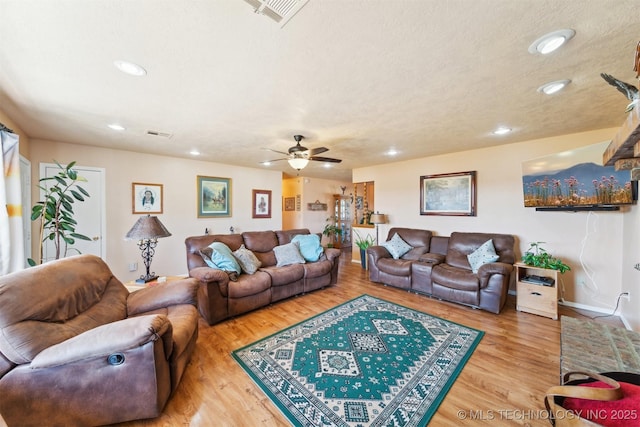 living room featuring ceiling fan, wood finished floors, visible vents, and recessed lighting