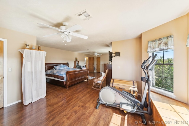 bedroom featuring wood finished floors, visible vents, and ceiling fan