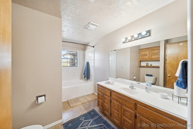 full bath featuring tile patterned floors, vanity, a textured ceiling, and toilet
