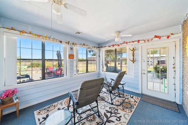 sunroom / solarium featuring a healthy amount of sunlight, carpet flooring, and visible vents