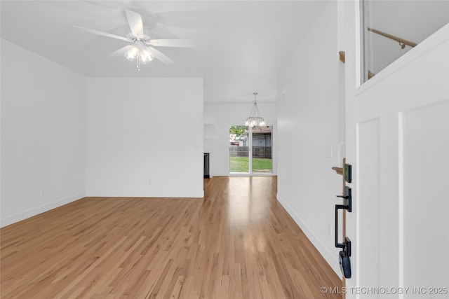 924 S Allegheny Ave, Tulsa, OK 74112 - interior space featuring a fireplace, baseboards, ceiling fan with notable chandelier, and light wood-style flooring
