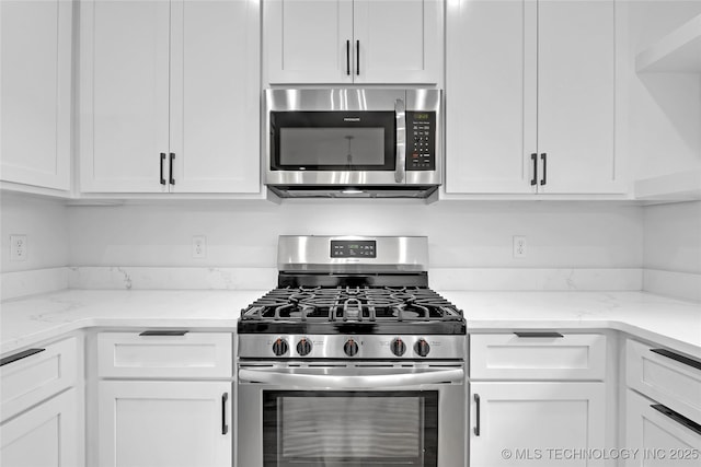 924 S Allegheny Ave, Tulsa, OK 74112 - kitchen with light stone countertops, white cabinetry, and appliances with stainless steel finishes