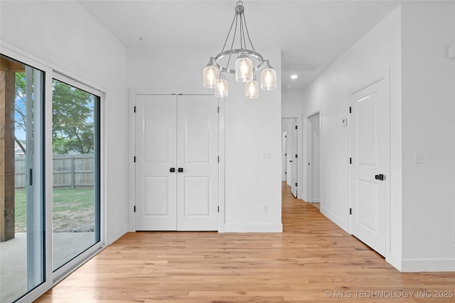 924 S Allegheny Ave, Tulsa, OK 74112 - unfurnished dining area featuring baseboards, a chandelier, and light wood-style flooring