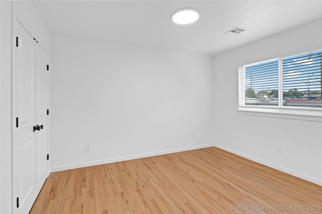 924 S Allegheny Ave, Tulsa, OK 74112 - unfurnished bedroom with baseboards, visible vents, light wood-style floors, and a closet