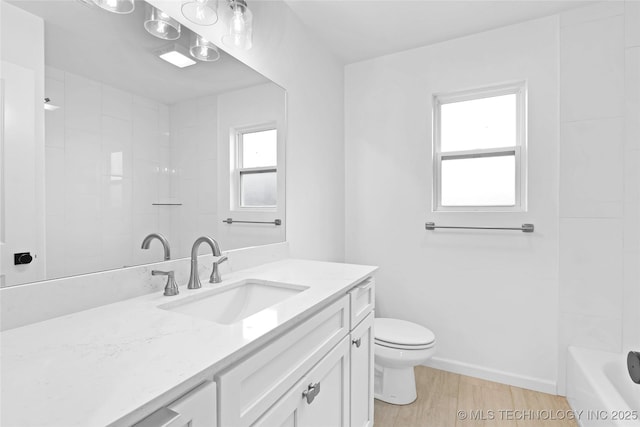 924 S Allegheny Ave, Tulsa, OK 74112 - bathroom featuring baseboards, wood finished floors, vanity, and toilet