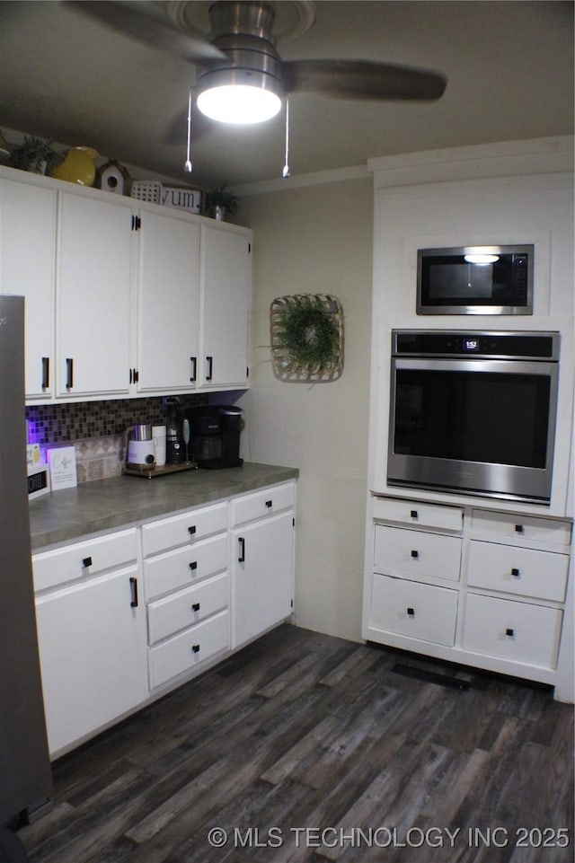 9996 N Millennium, Sulphur, OK 73086 - kitchen with crown molding, decorative backsplash, white cabinets, stainless steel appliances, and dark wood-style floors