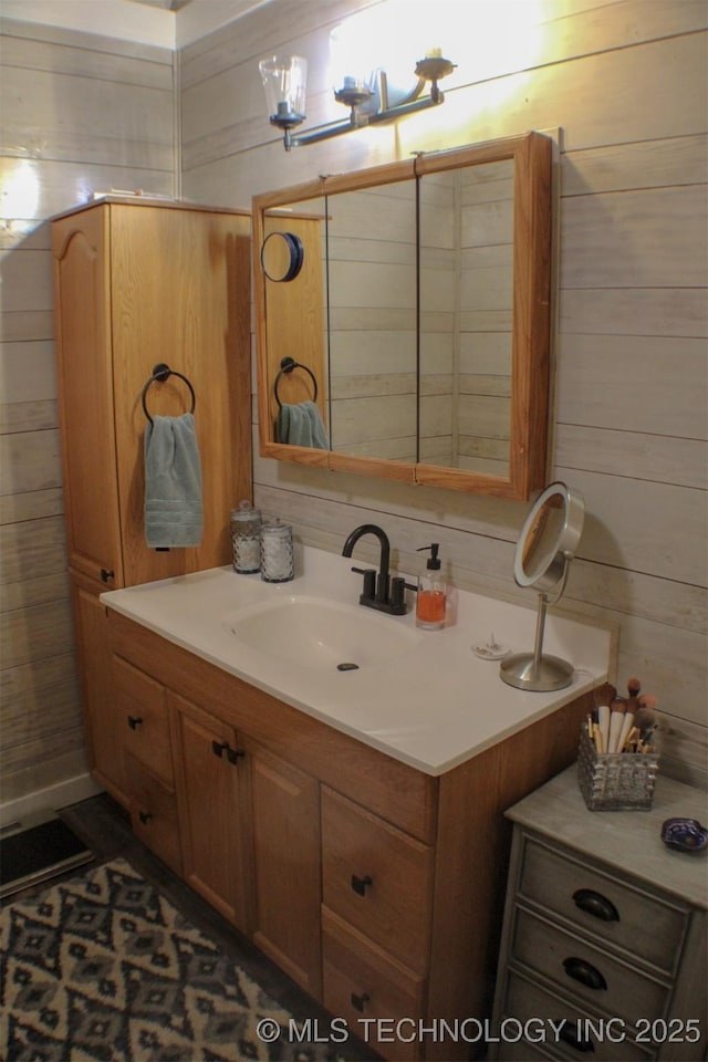 9996 N Millennium, Sulphur, OK 73086 - bathroom featuring visible vents, wood walls, and vanity