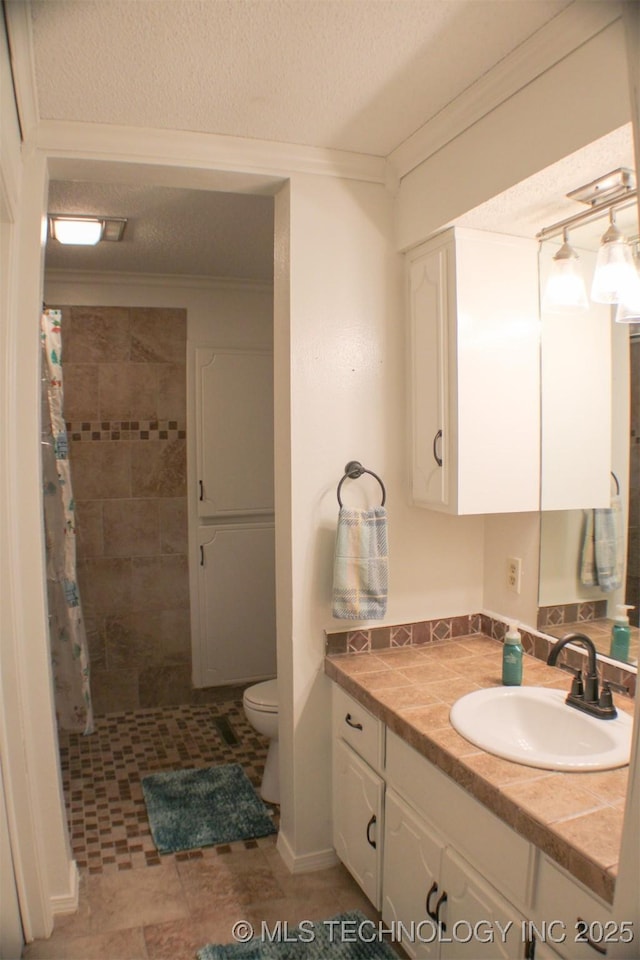 9996 N Millennium, Sulphur, OK 73086 - full bathroom with toilet, a tile shower, a textured ceiling, and vanity