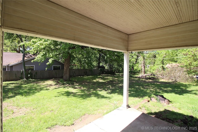 view of yard featuring fence and a patio