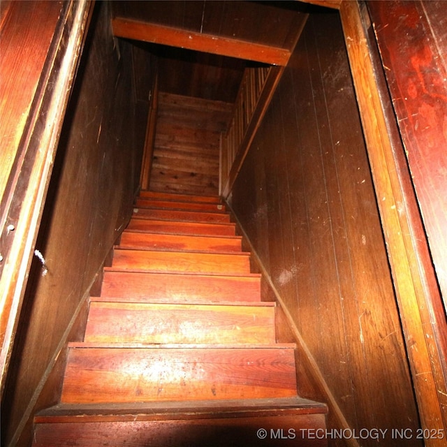 staircase with wooden walls