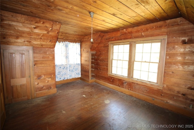 spare room featuring lofted ceiling, wood ceiling, and hardwood / wood-style flooring