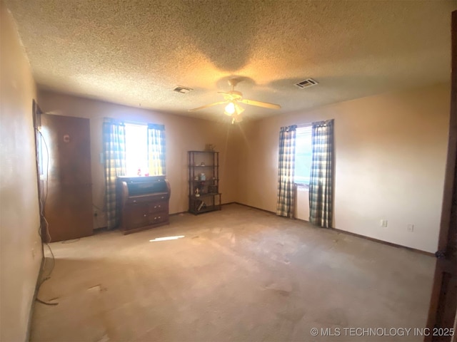 1320 Jennings St, Muskogee, OK 74403 - empty room featuring healthy amount of natural light, ceiling fan, light carpet, a textured ceiling, and baseboards