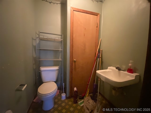 1320 Jennings St, Muskogee, OK 74403 - bathroom with a sink, toilet, and tile patterned floors