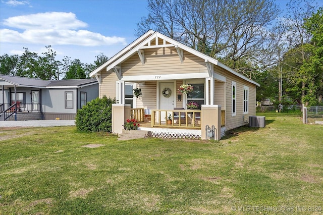 722 S Hughes Ave, Morris, OK 74445 - view of front of home featuring a porch, a front lawn, fence, and central AC