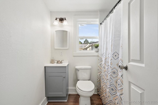 722 S Hughes Ave, Morris, OK 74445 - bathroom featuring wood finished floors, vanity, toilet, and baseboards