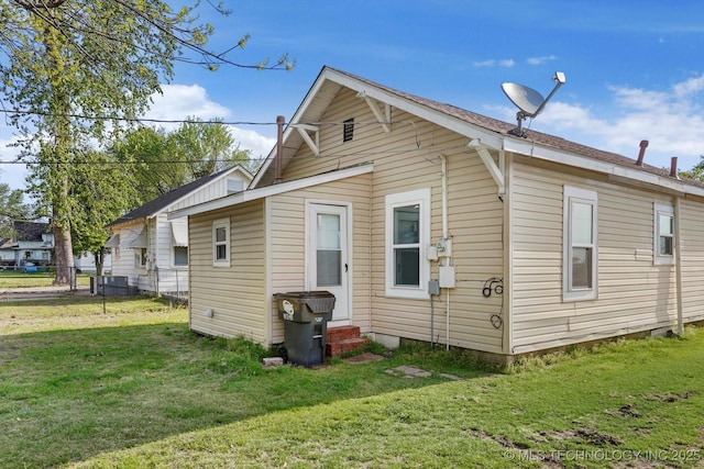 722 S Hughes Ave, Morris, OK 74445 - rear view of house featuring fence, a yard, and entry steps
