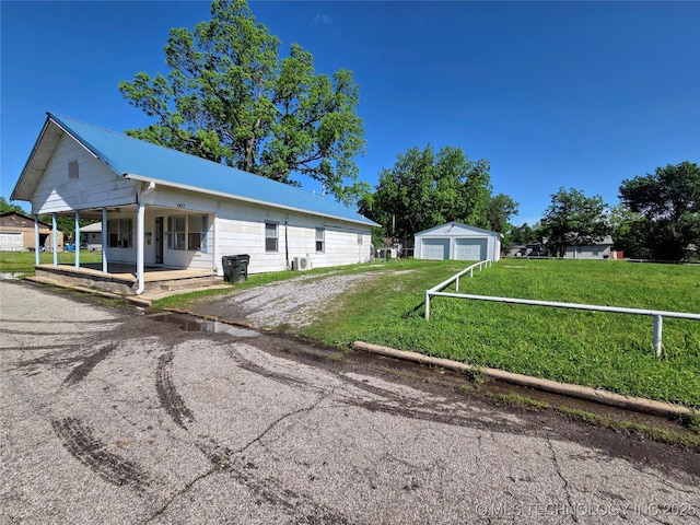 602 N Collins Ave, Okmulgee, OK 74447 - view of front of house with a porch, a front yard, and a garage