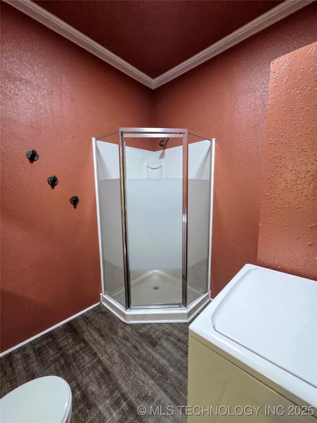 602 N Collins Ave, Okmulgee, OK 74447 - full bathroom with ornamental molding, a textured wall, washer / clothes dryer, and a stall shower