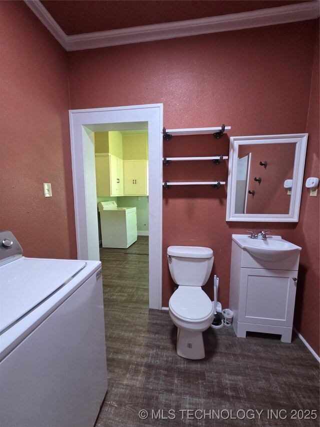 602 N Collins Ave, Okmulgee, OK 74447 - bathroom featuring washer / dryer, vanity, crown molding, and toilet