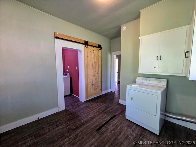 602 N Collins Ave, Okmulgee, OK 74447 - laundry room featuring dark wood-style flooring, washer / clothes dryer, a barn door, cabinet space, and baseboards