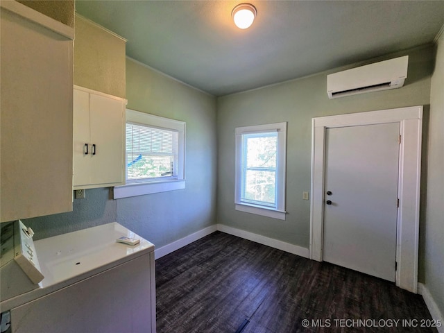 602 N Collins Ave, Okmulgee, OK 74447 - laundry area featuring baseboards, an AC wall unit, and dark wood finished floors
