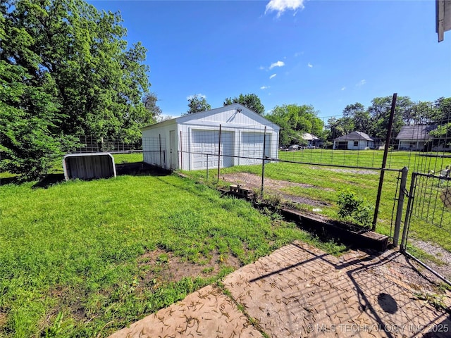 602 N Collins Ave, Okmulgee, OK 74447 - view of yard with fence, a detached garage, and an outbuilding