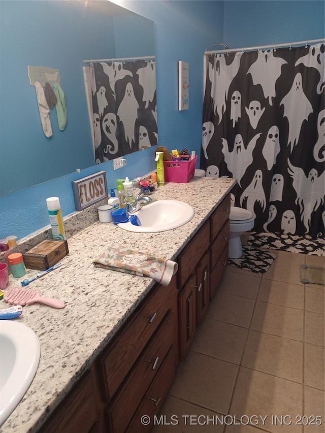 bathroom with tile patterned floors, vanity, a shower with shower curtain, and toilet
