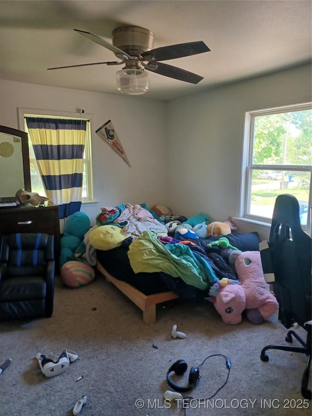 bedroom with carpet floors, a ceiling fan, and multiple windows