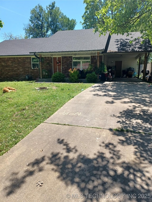ranch-style house featuring brick siding, driveway, a front lawn, and an attached carport