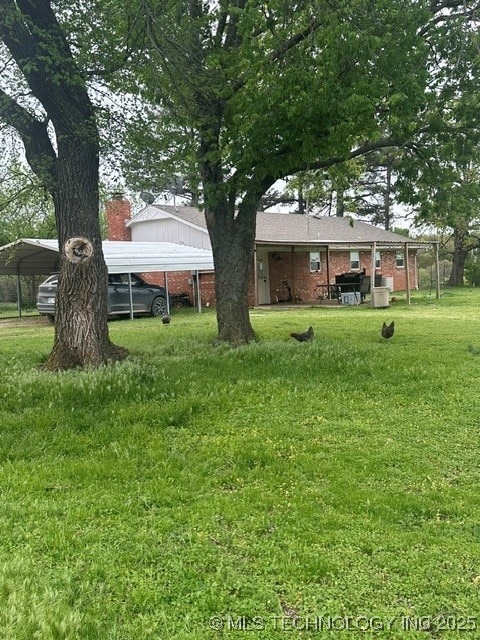 1414 N Eagle Rd, Yale, OK 74085 - view of yard with a carport
