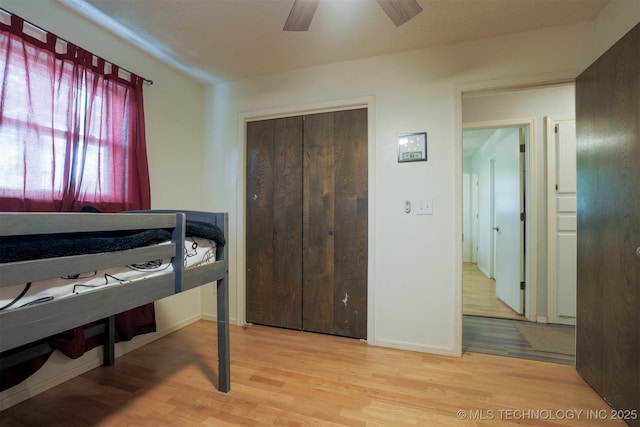 1414 N Eagle Rd, Yale, OK 74085 - bedroom with baseboards, a closet, a ceiling fan, and wood finished floors