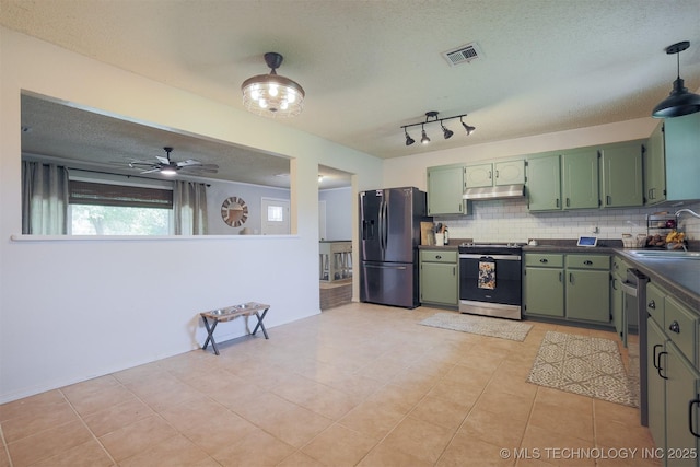 1414 N Eagle Rd, Yale, OK 74085 - kitchen featuring under cabinet range hood, decorative backsplash, stainless steel appliances, and green cabinets