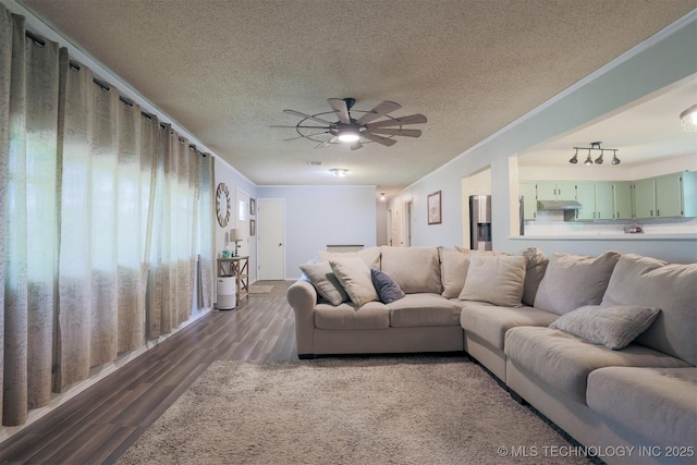 1414 N Eagle Rd, Yale, OK 74085 - living area with a textured ceiling, dark wood-type flooring, and a ceiling fan