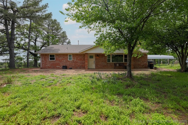 1414 N Eagle Rd, Yale, OK 74085 - back of house with brick siding and a carport