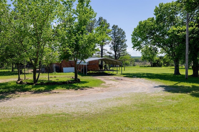 1414 N Eagle Rd, Yale, OK 74085 - view of front of property featuring dirt driveway, a detached carport, brick siding, and a front lawn