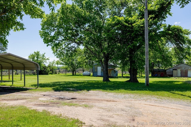 1414 N Eagle Rd, Yale, OK 74085 - view of yard with driveway, an outbuilding, a shed, and a carport