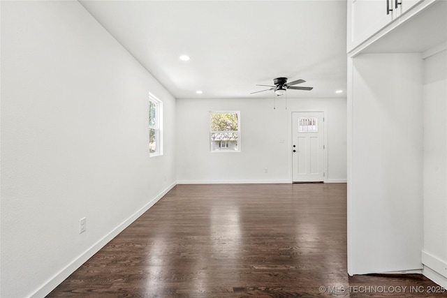 unfurnished living room with recessed lighting, baseboards, a ceiling fan, and dark wood-style floors