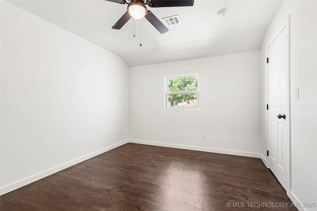spare room with vaulted ceiling, baseboards, visible vents, ceiling fan, and dark wood-type flooring