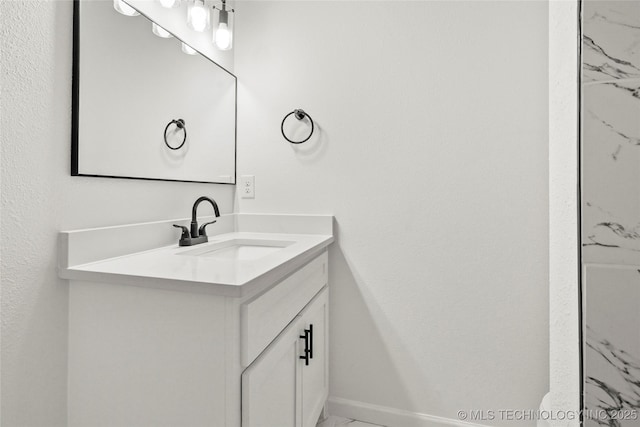 bathroom with baseboards and vanity