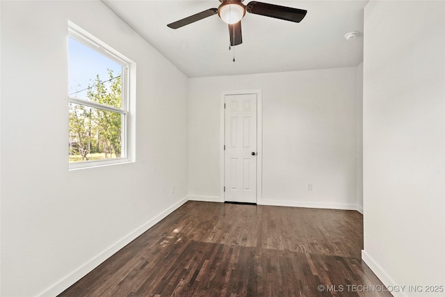 spare room with baseboards, a ceiling fan, and wood finished floors