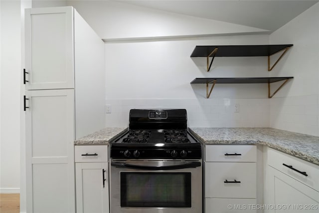 1910 E Marshall Pl, Tulsa, OK 74110 - kitchen with stainless steel gas range oven, open shelves, decorative backsplash, and white cabinets