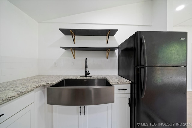 1910 E Marshall Pl, Tulsa, OK 74110 - kitchen featuring freestanding refrigerator, open shelves, a sink, backsplash, and light stone counters