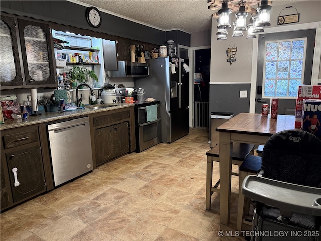 713 6th Ave, Warner, OK 74469 - kitchen with stainless steel appliances, a sink, a textured ceiling, dark brown cabinets, and a chandelier