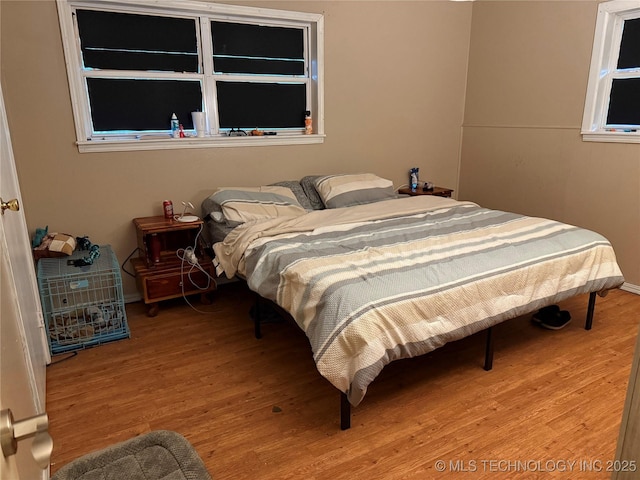 713 6th Ave, Warner, OK 74469 - bedroom featuring wood finished floors and baseboards